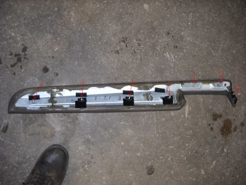 1993 Ford C-150 (Centurion Conversions) - A disassembled interior trim piece lies on a concrete surface, marked with red arrows and handwritten numbers.