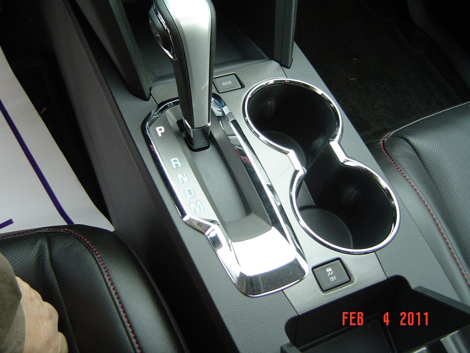 Center console with automatic shifter, cup holders, and ECO button in black interior