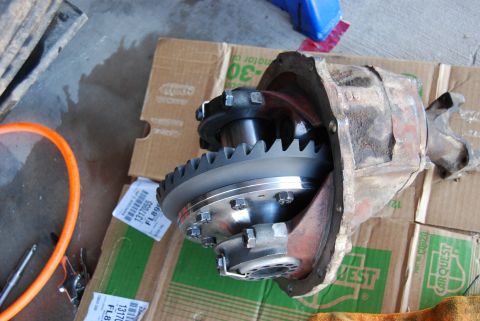 1982 Ford Bronco - A disassembled differential housing with its internal gears exposed, resting on a cardboard box.