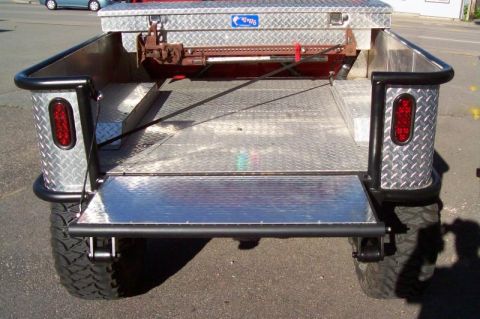 1989 Ford Bronco - Rear view of a custom pickup truck bed with diamond plate flooring and a toolbox mounted on top.