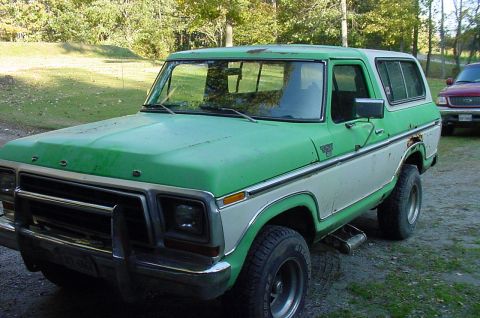 1979 Ford Bronco - A two-tone green and white Ford Bronco from 1978 is parked outdoors with another vehicle in the background.