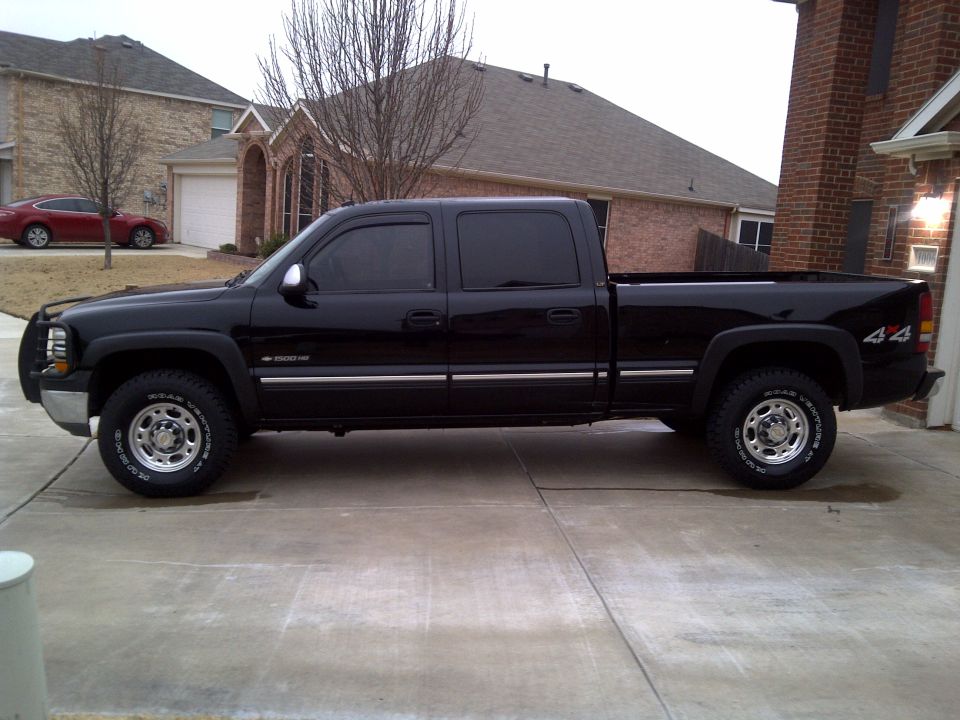 Side view of black 2002 Chevrolet Silverado 1500 pickup truck with 4x4 badging