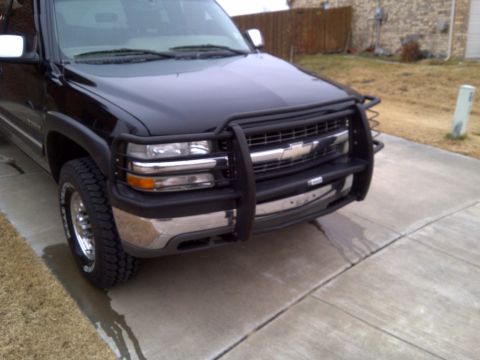 2002 Chevrolet Silverado 1500 - This truck has a prominent bull bar attached to its front end, covering the grille and bumper area.