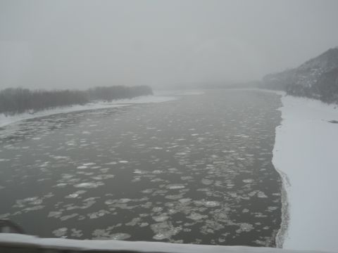 2009 Kenworth T800 - Winter scene of a river partially covered in ice floes under a cloudy sky.
