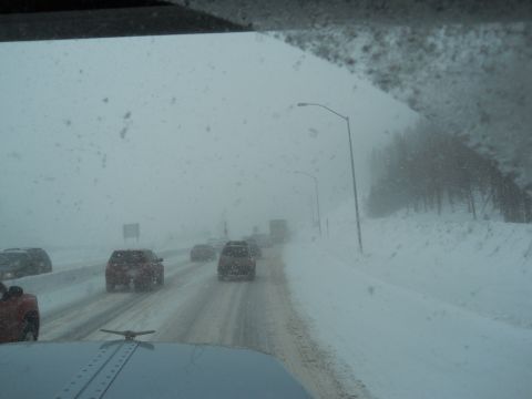 2009 Kenworth T800 - Driving through a blizzard on a highway with multiple vehicles on the road.