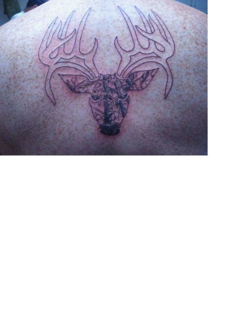 1993 Ford Bronco - A tattoo of a deer head with camouflage filling the face is visible on a person's back.