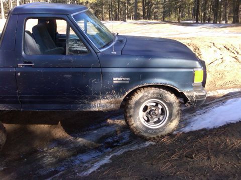 1988 Ford Bronco - This 1988 Ford Bronco is seen on a muddy, off-road trail with patches of snow.