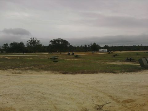 1995 Ford Bronco - An RV is visible in the distance at a park with picnic tables scattered across the grass.