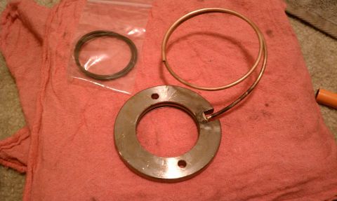 1990 Ford Bronco - Several metal rings and a gasket are laid out on a red cloth, with a Supermotors.net watermark at the bottom right.