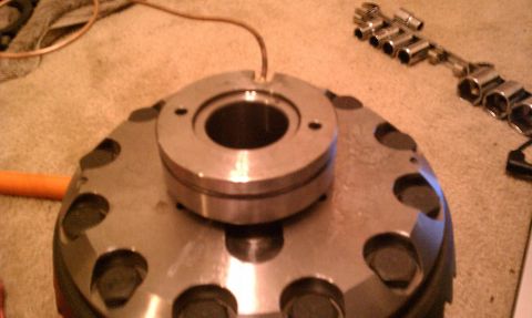 1990 Ford Bronco - Metal differential part with attached wire and socket wrenches on a textured surface.