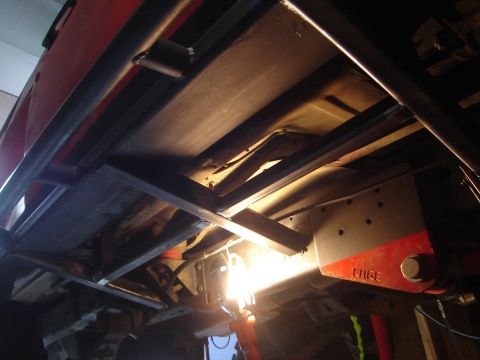 1989 Ford Bronco - Custom metalwork is visible on the undercarriage of this vehicle, with a component marked 'CAGE'.
