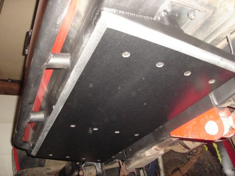 1989 Ford Bronco - Close-up view of an aftermarket skid plate installed on the undercarriage of a vehicle.