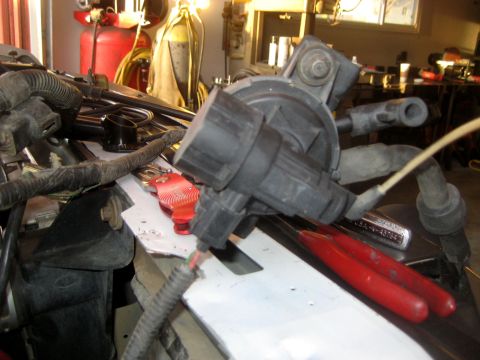 1996 Ford Bronco - Engine component and tools in a workshop setting.