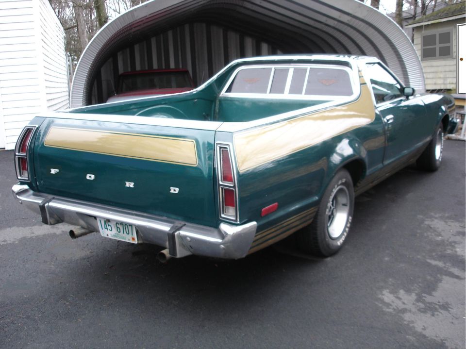 Green and tan Ford Ranchero, rear 3/4 view, with NH plate, parked by a metal carport.