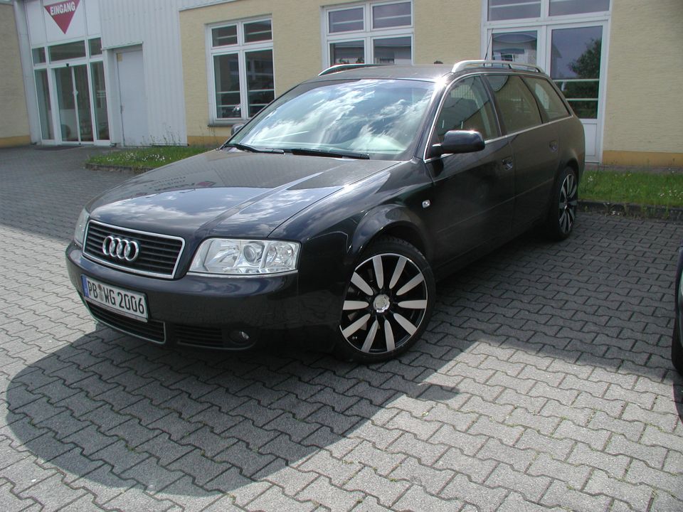 Black Audi wagon parked on a paved lot. License plate reads PB 1WG 2006