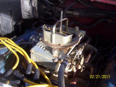 1978 Ford Bronco - A close-up view of a Holley carburetor, part of a vehicle's engine system.