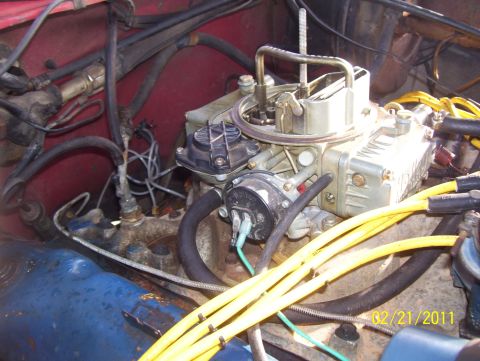 1978 Ford Bronco - Close-up view of an engine's carburetor and associated wiring and hoses.