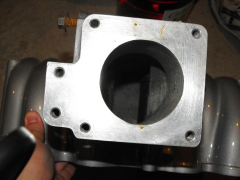 1994 Ford Bronco - A throttle body is shown, a crucial component of the engine's air intake system.