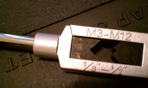 1990 Ford Bronco - A tap and die set is shown, markings for M3-M12 and 1/8"-1/2" sizes.