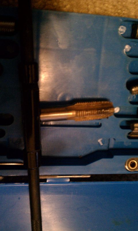 1990 Ford Bronco - A tap tool is shown in its blue storage case, part of a set.