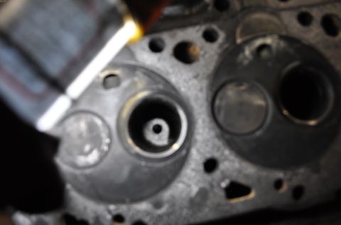 1984 Ford Bronco - Engine cylinder head with visible valve seats and bolt holes.