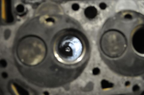 1984 Ford Bronco - Detail of an engine's cylinder head, showing the combustion chambers and valves.