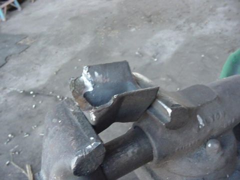 1992 Ford Bronco - Close-up of a steering knuckle arm boss on an axle knuckle after the old arm was torch-cut and ground away, leaving bright bare metal and s…