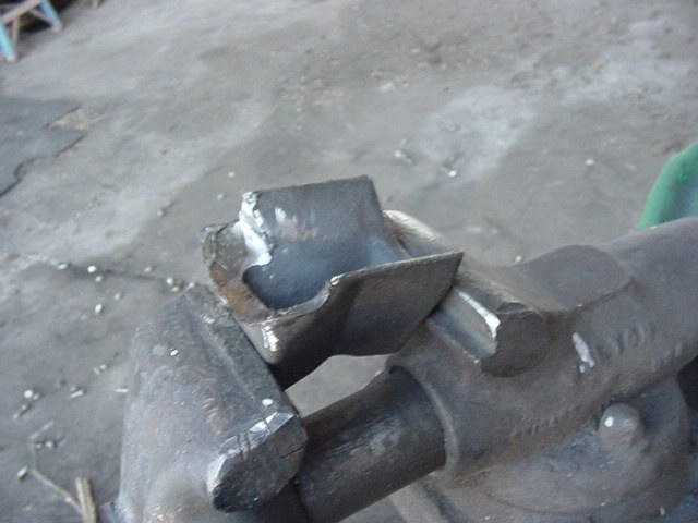 Axle knuckle with steering arm boss torch-cut and ground to bare metal