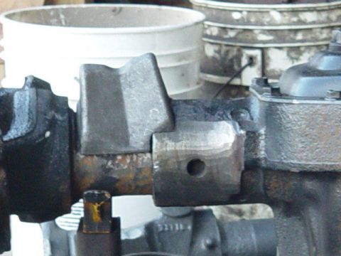 1992 Ford Bronco - Close-up view of a rusty metal component, likely a vehicle part, showing bolts and a drilled hole.