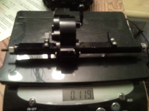 1989 Ford Bronco - RC car differential assembly is weighed on a digital scale.