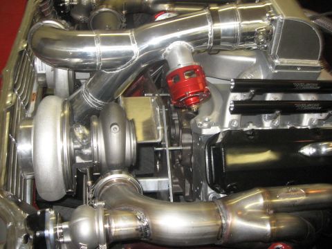 1965 Ford Fairlane - Close-up view of a custom engine build twin turbochargers and polished exhaust components.