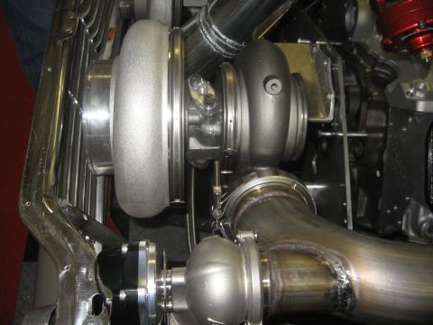 1965 Ford Fairlane - Close-up of a turbocharger system with exhaust manifold and piping.