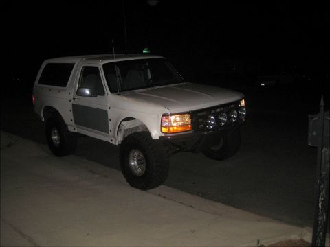 1996 Ford Bronco - A modified 1992 Ford Bronco is shown from a three-quarter front view at night.