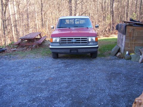 1989 Ford F-150 - Front view of a red 1989 Ford F-150 pickup truck parked outside.