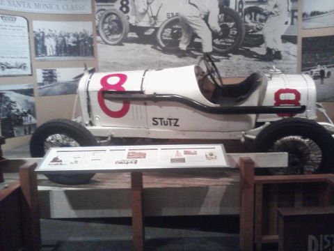 1995 Ford Taurus - A vintage Stutz race car, number 8, is exhibited with historical photographs and information panels.