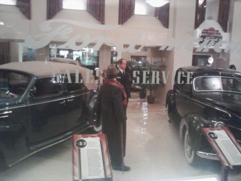 1995 Ford Taurus - Vintage automobiles are exhibited at the Peterson Automotive Museum, with signage indicating sales and service.