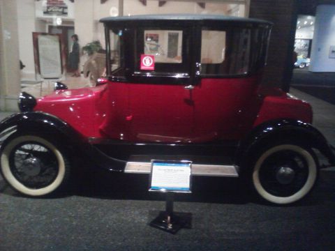 1995 Ford Taurus - A 1914 Detroit Electric car is displayed indoors, likely at a museum.