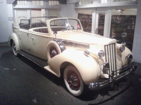 1995 Ford Taurus - This vintage convertible, likely from the 1930s, is displayed indoors, possibly at a museum.