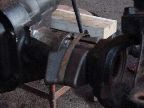 1992 Ford Bronco - Close-up view of a vehicle axle assembly, showing metal components and a strap.