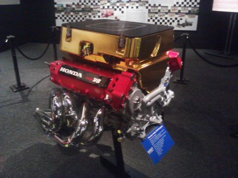 1995 Ford Taurus - A Honda V8 engine, displayed with a gold casing and chrome exhaust, is labeled with the year 2007.