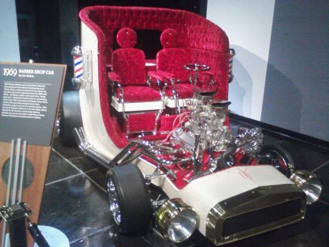 1995 Ford Taurus - A unique 1969 Barber Shop Car, originally built by Joe Balboni, is displayed with its plush red interior and prominent V8 engine.