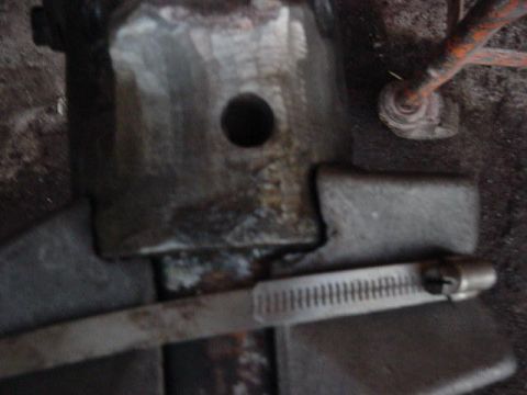 1992 Ford Bronco - A metal bracket secured with a hose clamp is shown in this close-up view.