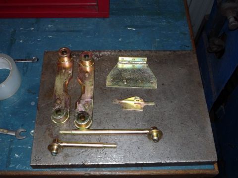 1969 MINI Cooper - Various car suspension components are arranged on a workbench, ready for assembly or inspection.