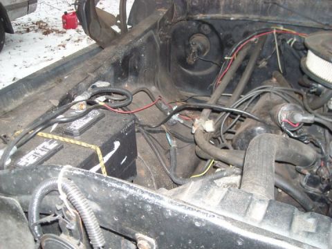 1979 Ford Bronco - Close-up view of an engine bay, focusing on the battery and associated components.