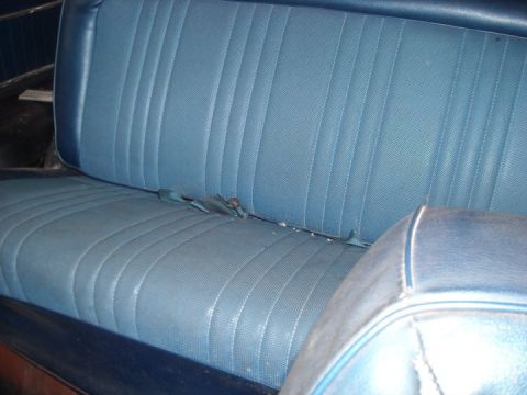 1979 Ford Bronco - Interior shot of a blue vinyl bench seat with seatbelts.