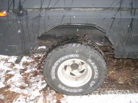 1979 Ford Bronco - The rear wheel well and tire of a 1979 Ford Bronco are visible in this side view.