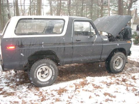1979 Ford Bronco - Ford Bronco with hood open, parked in a snowy outdoor setting.