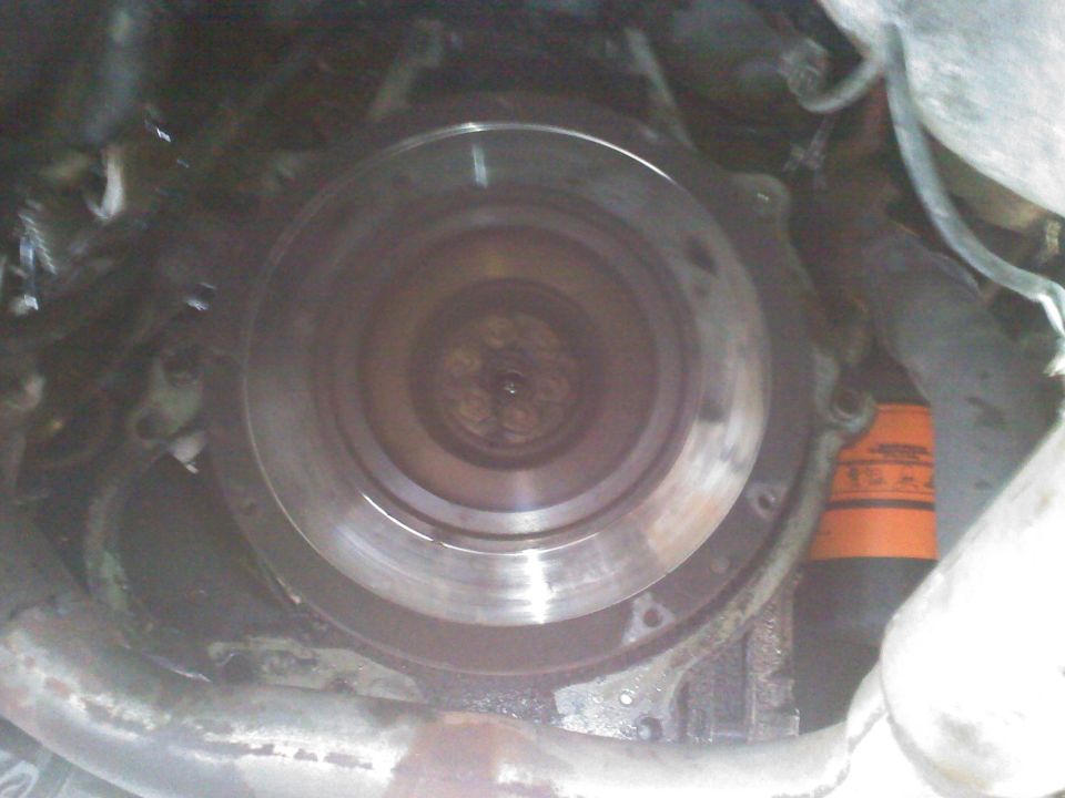 Close-up of flywheel and orange oil filter