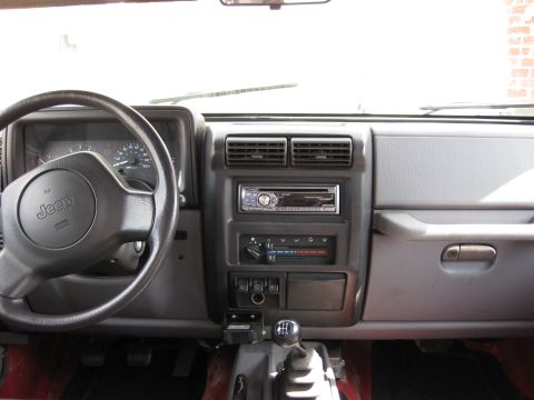 1998 Jeep Wrangler - Interior view of a 1998 Jeep Wrangler, showing the dashboard, steering wheel, and center console.