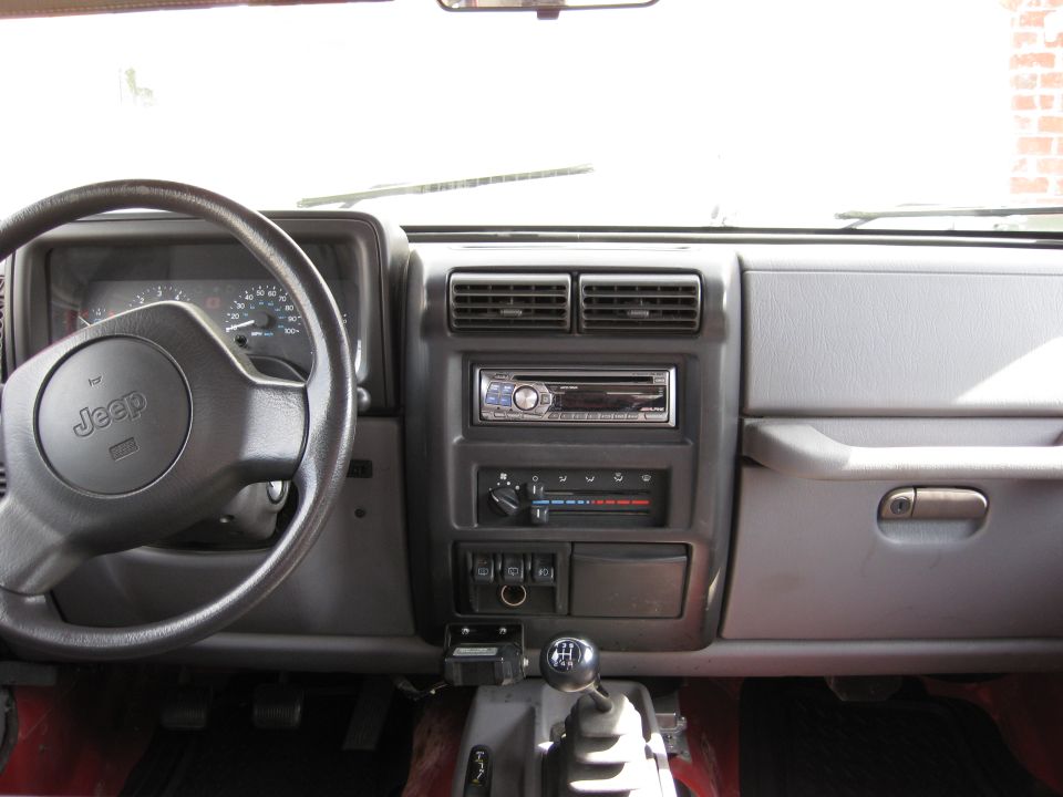 1998 Jeep Wrangler interior with Jeep steering wheel and dashboard